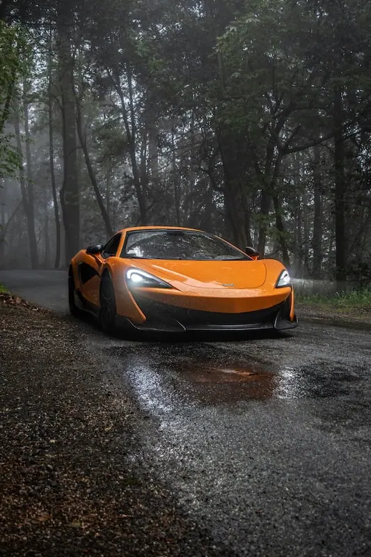 sports car driving in the rain